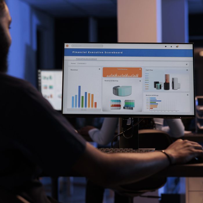 Young businessman looking at computer monitor with charts, analyzing statistics information and data to create project report, doing financial research. Pc screen with network presentation.